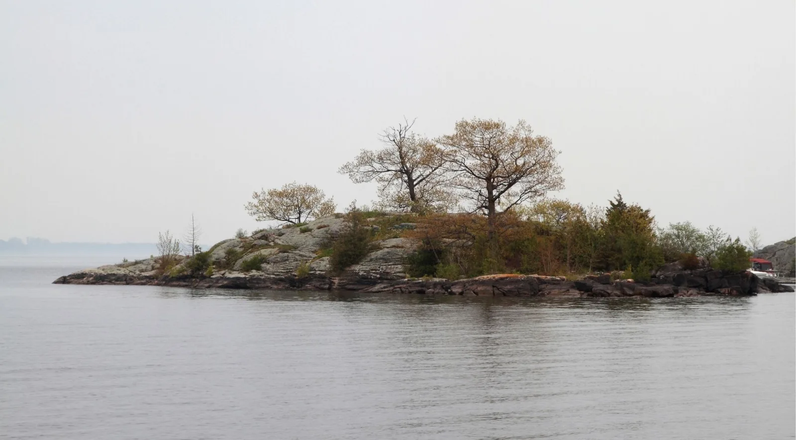 Rocky island silhouette on the misty St. Lawrence River