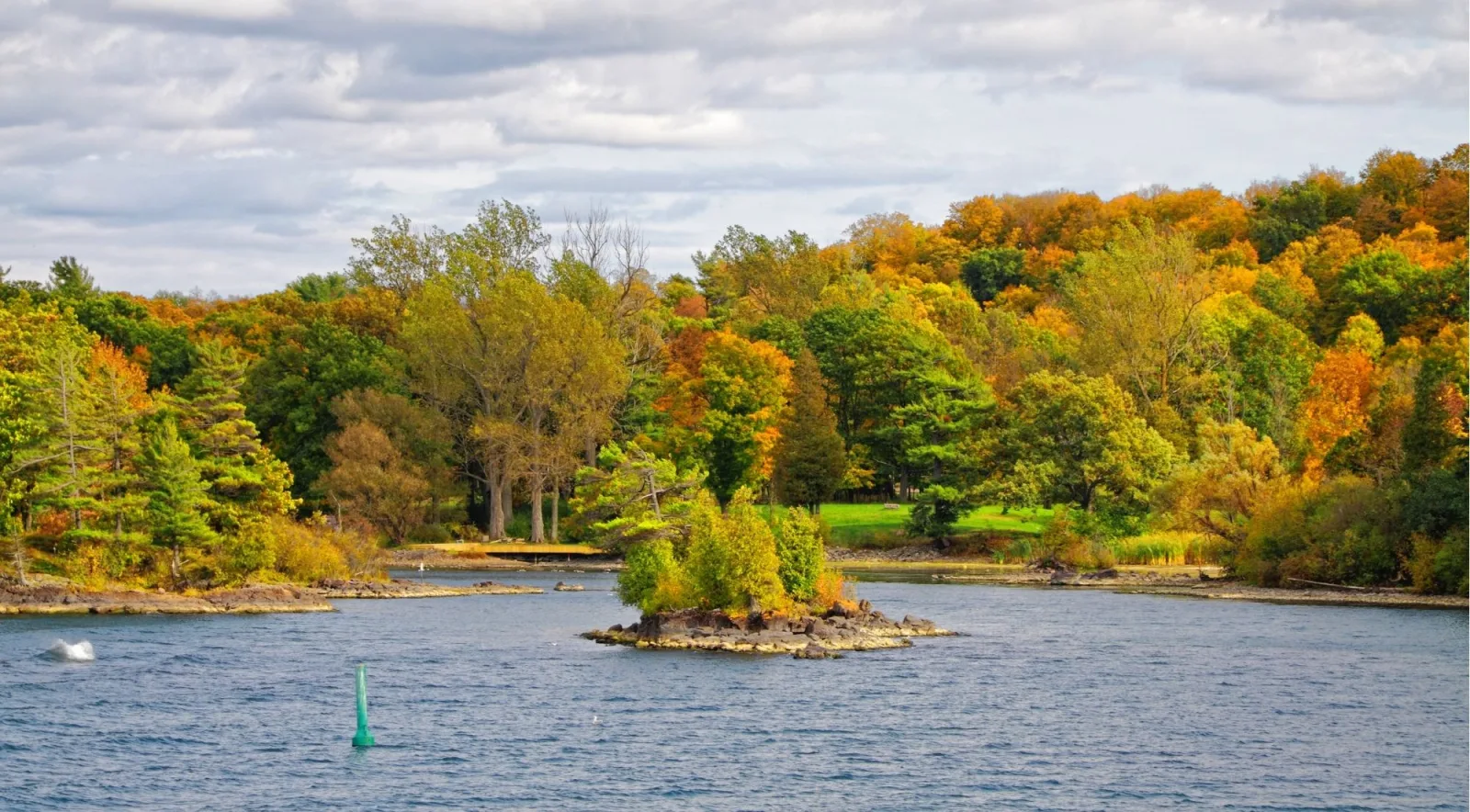 Autumn shoreline and small island with a navigation buoy on the St. Lawrence River
